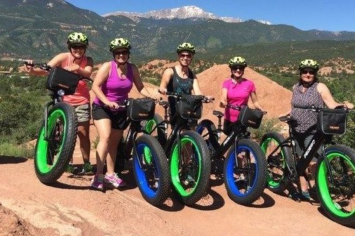 a group of people standing around a motorcycle